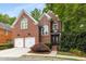 Charming two-story brick home with manicured landscaping and attached two car garage at 1143 Brookhaven North Cir, Brookhaven, GA 30319