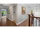 Well-lit hallway with hardwood floors, decorative lighting, and neutral paint at 1143 Brookhaven North Cir, Brookhaven, GA 30319