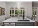 Beautiful kitchen island with white countertops, seating, sink, and stylish pendant lighting at 1143 Brookhaven North Cir, Brookhaven, GA 30319