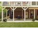 Under-deck patio featuring artificial turf, a wrought iron spiral staircase, and a dining set at 1143 Brookhaven North Cir, Brookhaven, GA 30319