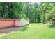 A lush green backyard featuring a shed and ample space for outdoor activities at 207 Walthall Nw St, Marietta, GA 30064