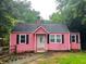 Charming pink home with black shutters and a well-maintained front yard at 207 Walthall Nw St, Marietta, GA 30064