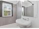 Cozy bathroom featuring a stylish sink, gray tiling, and a window for ample natural light at 2776 Grand Ave, Atlanta, GA 30315