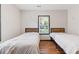 This bedroom features two twin beds, hardwood floors, neutral walls, and a sunlit window at 2776 Grand Ave, Atlanta, GA 30315