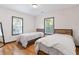 Bedroom featuring two twin beds, two windows with hardwood floors at 2776 Grand Ave, Atlanta, GA 30315