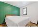 Bedroom featuring painted accent wall, window, hardwood floors and ceiling fan at 2776 Grand Ave, Atlanta, GA 30315