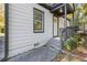 Close up of the white home's entryway showing steps up to a covered porch at 2776 Grand Ave, Atlanta, GA 30315