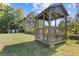 A beautiful gazebo is surrounded by lush lawn and mature trees in the backyard at 2776 Grand Ave, Atlanta, GA 30315