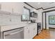This kitchen offers bright white cabinets, stainless steel appliances, quartz countertops, and subway tile backsplash at 2776 Grand Ave, Atlanta, GA 30315