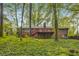 Backyard with privacy, featuring a deck, stairs, chimney, and mature trees at 333 Lynne Cir, Alpharetta, GA 30009