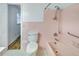 Retro bathroom with pink tiling, tub and toilet at 333 Lynne Cir, Alpharetta, GA 30009