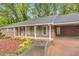 The front of this brick home features a covered porch, carport and well-maintained landscaping at 333 Lynne Cir, Alpharetta, GA 30009