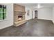 Spacious living room featuring a cozy brick fireplace, large windows, and neutral walls at 333 Lynne Cir, Alpharetta, GA 30009