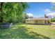 Backyard view of a single-Gathering home with a storage building and mature trees at 1554 Owens Store Road Rd, Canton, GA 30115