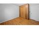 Bedroom features wood paneled closet, hardwood floors, and neutral finishes at 1554 Owens Store Road Rd, Canton, GA 30115