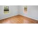 Corner bedroom featuring neutral paint, hardwood floors, and bright windows at 1554 Owens Store Road Rd, Canton, GA 30115