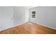 Cozy bedroom featuring hardwood floors, neutral paint, and bright window at 1554 Owens Store Road Rd, Canton, GA 30115