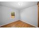 Bedroom features hardwood floors, neutral paint, and bright window at 1554 Owens Store Road Rd, Canton, GA 30115