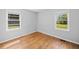 Corner bedroom featuring neutral paint, hardwood floors, and bright windows at 1554 Owens Store Road Rd, Canton, GA 30115