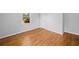 Bright bedroom features gleaming hardwood floors, fresh paint, and natural light at 1554 Owens Store Road Rd, Canton, GA 30115
