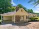 Inviting one-story home with a covered entrance, brick accents, and freshly landscaped features at 1554 Owens Store Road Rd, Canton, GA 30115