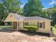 Inviting single-story home with covered porch and well-maintained front yard landscaping at 1554 Owens Store Road Rd, Canton, GA 30115