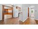 Spacious kitchen with access to other rooms, features white refrigerator and dark countertops at 1554 Owens Store Road Rd, Canton, GA 30115