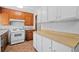Bright kitchen featuring two-toned cabinets, white appliances, and ample counter space at 1554 Owens Store Road Rd, Canton, GA 30115