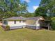 Exterior showcasing backyard deck and lush landscaping, with a walkout basement and freshly laid mulch at 1554 Owens Store Road Rd, Canton, GA 30115