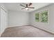 A bright bedroom featuring neutral walls, plush carpeting, and abundant natural light from one large window at 2145 Kensington Sw Ct, Marietta, GA 30064