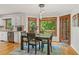 Bright dining room features backyard views, hardwood floors and elegant lighting at 2145 Kensington Sw Ct, Marietta, GA 30064