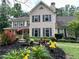 Charming two-story home with mature landscaping, an American flag, and a welcoming front porch at 2145 Kensington Sw Ct, Marietta, GA 30064