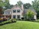 Charming two-story home with mature landscaping, an American flag, and a welcoming front porch at 2145 Kensington Sw Ct, Marietta, GA 30064