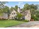 Charming two-story home with mature landscaping, an American flag, and a long driveway at 2145 Kensington Sw Ct, Marietta, GA 30064