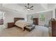 Spacious main bedroom featuring tray ceilings, natural light, plush carpet and ensuite bathroom at 2145 Kensington Sw Ct, Marietta, GA 30064