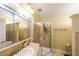 A well-lit bathroom features a glass shower stall and a decorative mirror, offering a spa-like experience at 295 Pinehurst Dr, Stockbridge, GA 30281