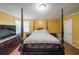 A sunlit bedroom features a classic four-poster bed, creating a peaceful and inviting retreat at 295 Pinehurst Dr, Stockbridge, GA 30281