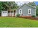 Charming single-story house with a well-kept lawn, inviting porch, and attached garage at 295 Pinehurst Dr, Stockbridge, GA 30281