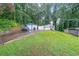 The property features multiple garages and additional parking space, set against a backdrop of lush greenery at 295 Pinehurst Dr, Stockbridge, GA 30281