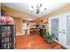 An open kitchen with warm wood flooring and a breakfast bar invites gatherings in this cozy home at 295 Pinehurst Dr, Stockbridge, GA 30281