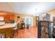Bright eat-in kitchen with wood cabinets, hardwood floors, and stainless appliances at 295 Pinehurst Dr, Stockbridge, GA 30281