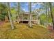 Exterior of home with covered deck overlooking backyard at 3115 Chimney Cove Ln, Cumming, GA 30041