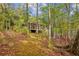 Home exterior with wooden deck, offering scenic views and outdoor living space at 3115 Chimney Cove Ln, Cumming, GA 30041