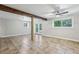 Spacious basement with tile flooring, exposed beam, and natural light from windows and glass doors at 3115 Chimney Cove Ln, Cumming, GA 30041