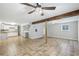 Large basement area with tile floors, wooden support beams and a view into the kitchen at 3115 Chimney Cove Ln, Cumming, GA 30041
