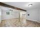 Basement features tile flooring, wooden support beams, with a view into the kitchen at 3115 Chimney Cove Ln, Cumming, GA 30041