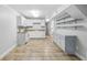 Basement kitchen features tile flooring, ample white cabinets and great lighting at 3115 Chimney Cove Ln, Cumming, GA 30041