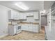 This basement kitchen features white appliances, ample lighting and lots of cabinets at 3115 Chimney Cove Ln, Cumming, GA 30041