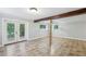Large basement featuring tile flooring, two windows, and French doors leading to the outside at 3115 Chimney Cove Ln, Cumming, GA 30041