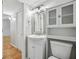 This features a white vanity with storage, modern fixtures, and a decorative mirror at 3115 Chimney Cove Ln, Cumming, GA 30041